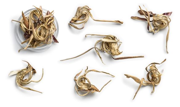 Dry artichoke flowers on a white background. The view from the top.