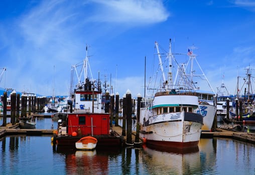 A pair of old fishing boats tied to a pier