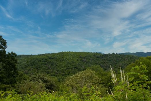 A scenic vista across the mountains under a cloudy sky