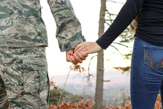 A soldier holding his wife hand. US Military couple holding hands. this image was taken on Dallas, Texas, USA on March 2019.