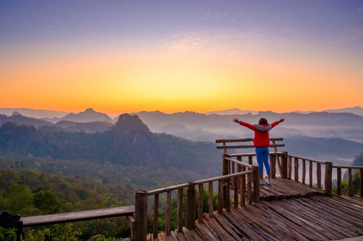 Young people are feeling the cool morning air with a sea of mist in front of Mae Hong Son Baan Jabo Thailand