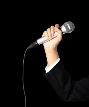 Reporter hand holding a microphone isolated on black background, clipping path