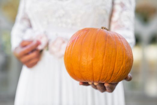 Halloween Ghost Bride holding pumpkin in her hands