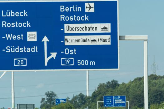 Autobahn sign in Germany Caption on German - city names Berlin, Rostock, Lübeck