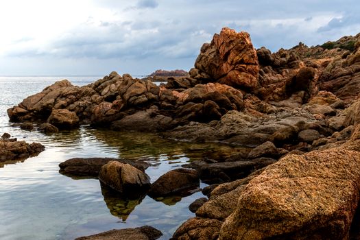 Beautiful bay of red rocks on Sardinia near the village Isola Rossa