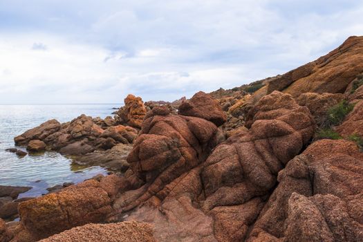 Beautiful bay of red rocks on Sardinia near the village Isola Rossa
