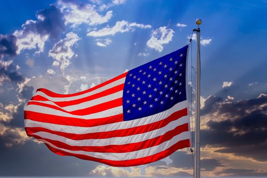 An american flag blowing in the wind with bright sunlight