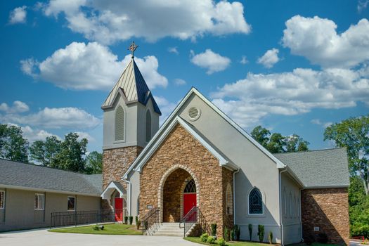 A methodist church of stone with a red door