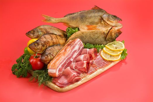 Smoked fish and vegetables on a studio background