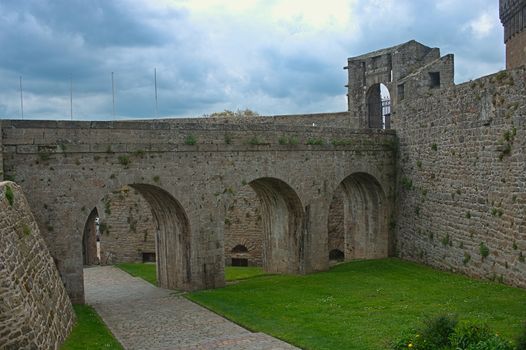 Big stone walls, gate and bridge at Dinan fortress, France