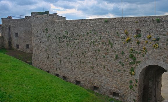 Big stone walls and gate at Dinan fortress, France