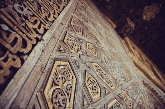 Intrincate details in a wooden double door in Sevilla's Alcaza, Spain