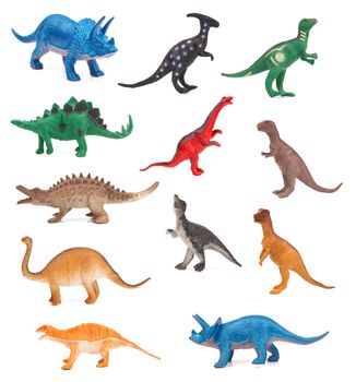 Group of toy dinosaurs on white background