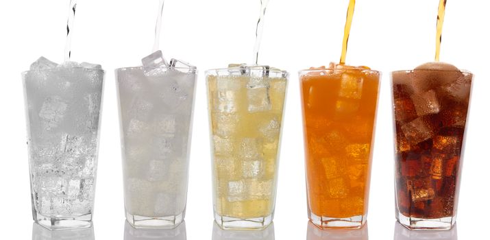 Glasses with sweet drinks with ice cubes isolated on white 