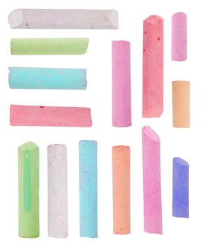 broken pieces of colored chalk isolated on white background