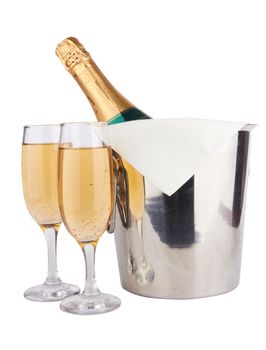 Champagne bottle in cooler and two champagne glasses 