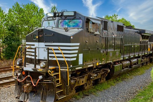 A black and white railroad locomotive on a track