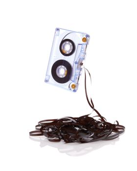 Audio cassette with tape tangle on white background