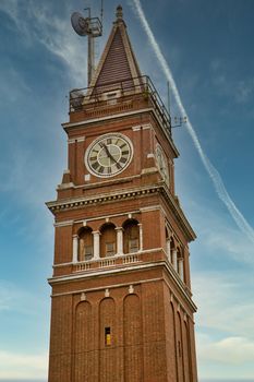 An old brick tower and clock on a cloudy day