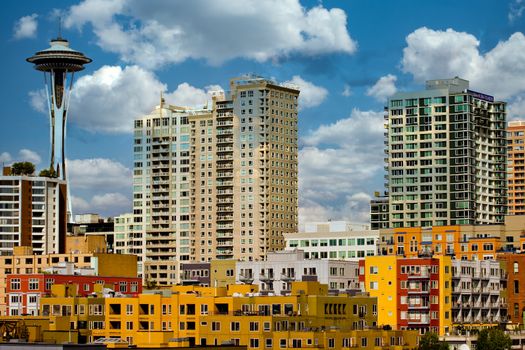 Many colorful buildings and space needle in the skyline of Seattle