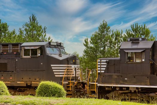 Two black train engines facing each other on track