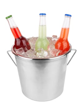Three bottles in bucket filled with ice isolated on white