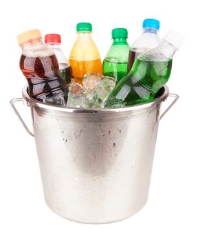 cold beverages in plastic bottles on heap of ice cubes