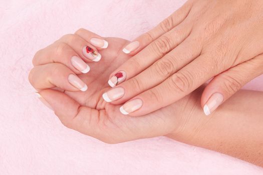 Hand with nail french manicure on pink background 