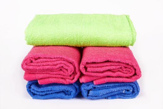 stacked colorful towels on a white background 