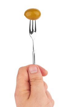 Olive on a fork in the hand on a white