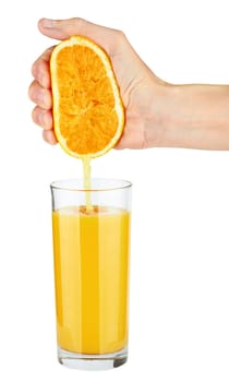 Pouring orange juice from orange into the glass isolated on white 