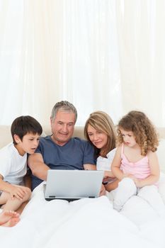 Family looking at their laptop at home