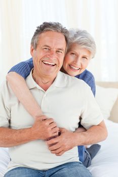 Senior couple looking at the camera at home