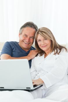 Couple looking at the camera at home