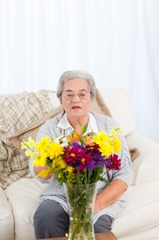 Senior with flowers at home