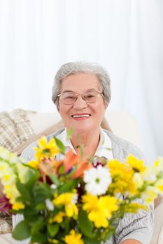Senior with flowers at home