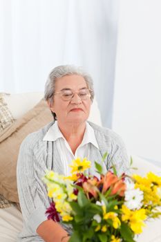 Senior with flowers at home