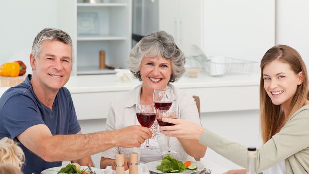 Family drinking wine together at home