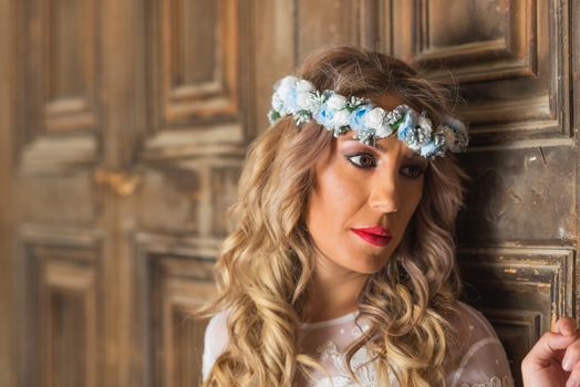 Beautiful bride portrait on old wooden door background