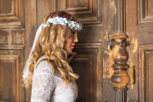 Beautiful bride portrait on old wooden door background