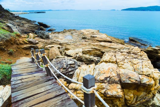 Wooden bridge to a tropical beach on island with blue sky, at khao laem ya mu koh samet island Rayong Thailand