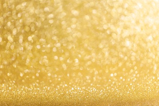 Abstract shining glitters gold holiday bokeh background with copy space for text