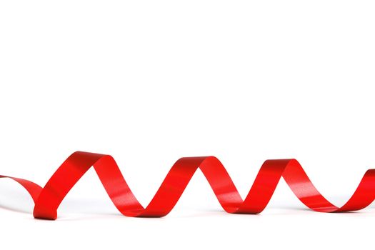 Curly red gift ribbon on white background close-up