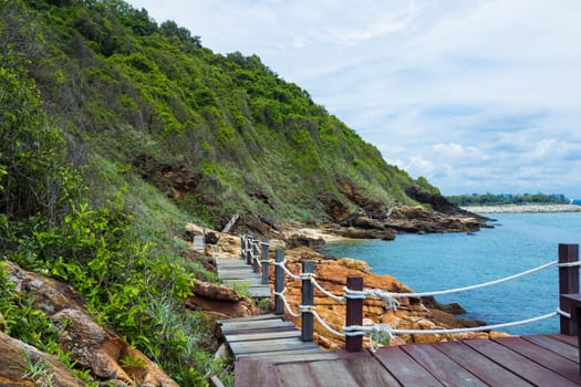 Wooden bridge to a tropical beach on island with blue sky, at khao laem ya mu koh samet island Rayong Thailand