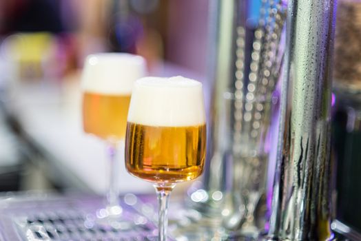 Two beer glasses in the tap of a pub