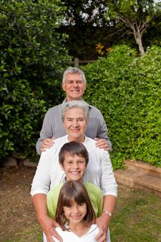 Grandparents with their grandchildren looking at the camera