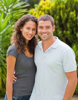 Happy couple hugging in the garden