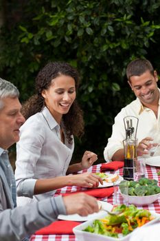 Happy family eating in the garden