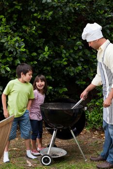 Family having a barbecue in the garden 