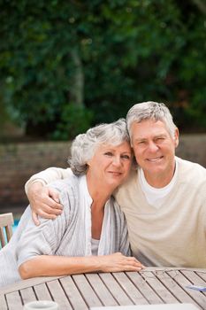 Senior couple hugging in the garden